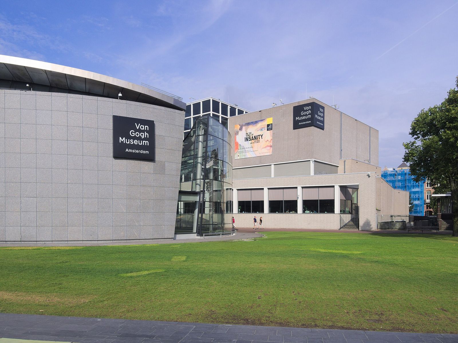 The Van Gogh Museum's curved grey stone wing and glass entrance hall on the Museumplein lawn