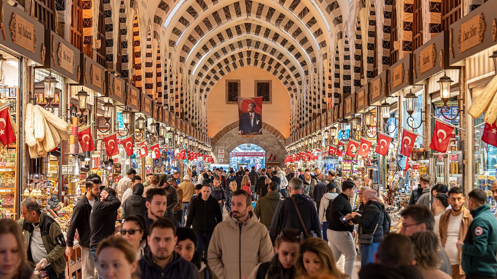 The Spice Bazaar's long vaulted hall, hung with Turkish flags and busy with shoppers