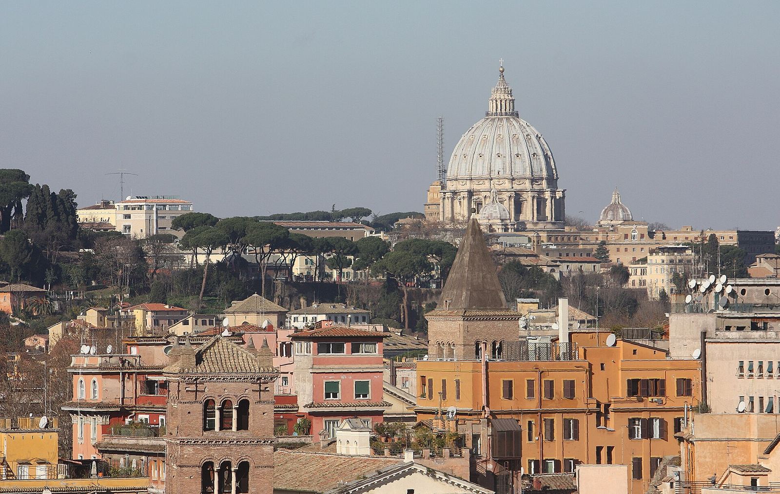 The daytime view from the Orange Garden terrace: St Peter's dome rising beyond the rooftops, umbrella pines and medieval bell towers on the far side of the Tiber